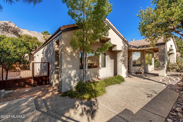 view of front of home with a mountain view and a patio