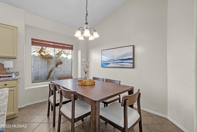 dining area with lofted ceiling, a notable chandelier, and light tile patterned flooring