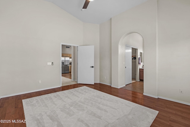 spare room featuring ceiling fan, hardwood / wood-style floors, and high vaulted ceiling