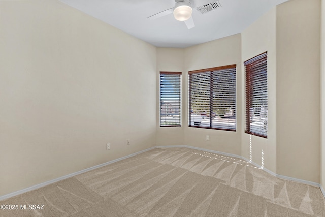 carpeted empty room featuring ceiling fan