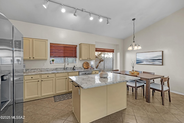 kitchen with a kitchen island, sink, and cream cabinetry