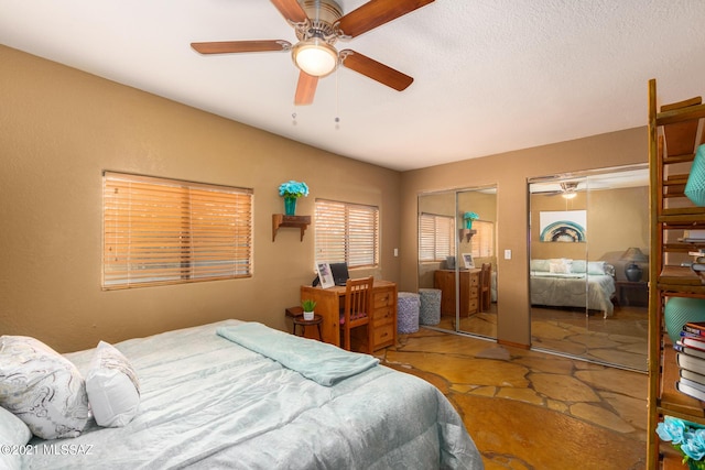 bedroom featuring multiple closets and ceiling fan