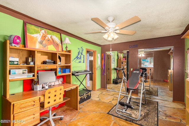 office area with ceiling fan and a textured ceiling