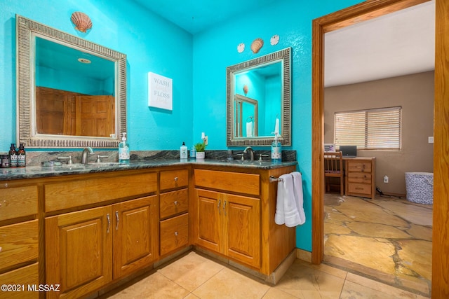 bathroom featuring tile patterned flooring and vanity