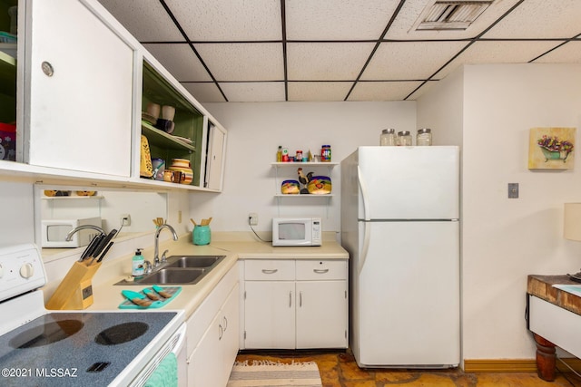 kitchen featuring white cabinets, white appliances, a paneled ceiling, and sink