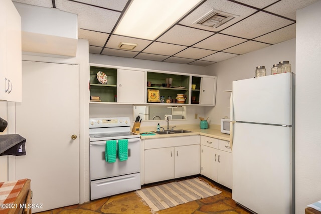 kitchen featuring white cabinets, white appliances, a paneled ceiling, and sink