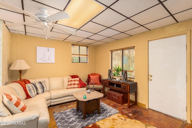 living room featuring a paneled ceiling and ceiling fan