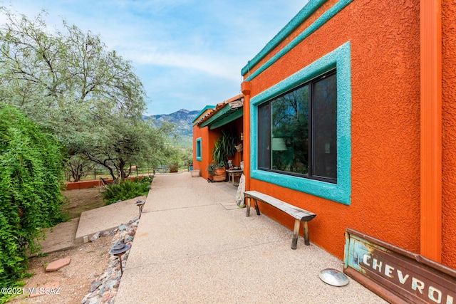 view of home's exterior featuring a mountain view and a patio area