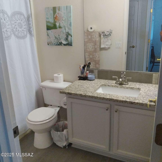 full bathroom with toilet and vanity
