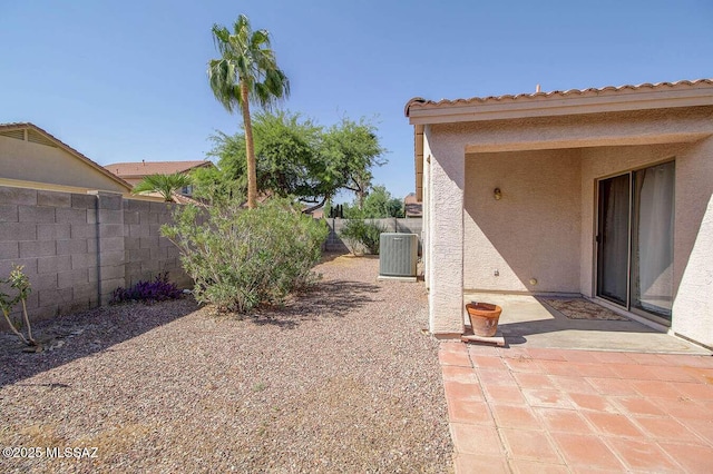 view of yard featuring a patio, cooling unit, and a fenced backyard