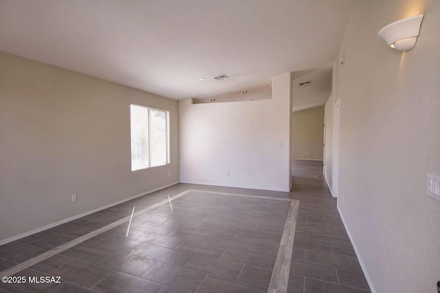 empty room featuring baseboards