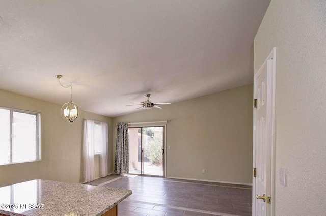 kitchen featuring baseboards, decorative light fixtures, and a ceiling fan