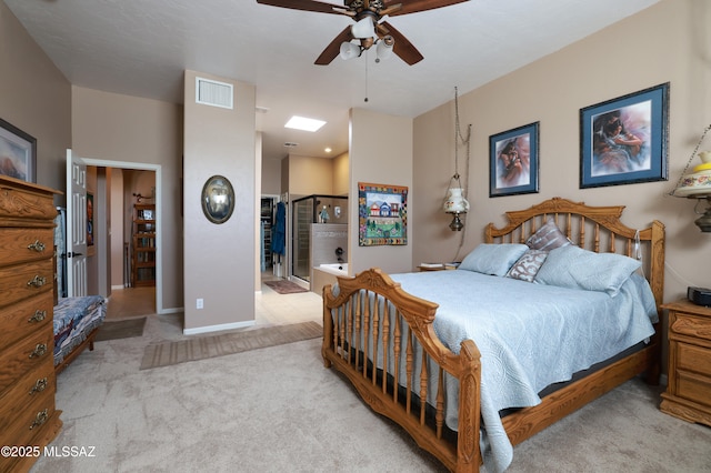 carpeted bedroom featuring connected bathroom and ceiling fan