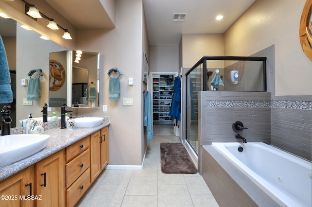 bathroom featuring tile patterned flooring, vanity, and shower with separate bathtub