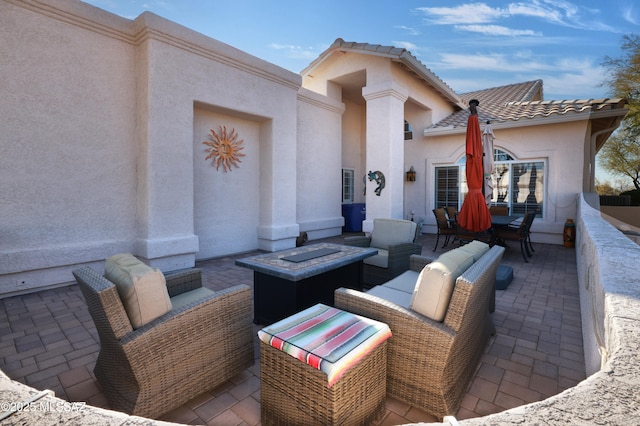 view of patio / terrace with an outdoor living space with a fire pit