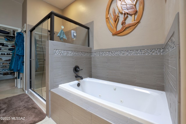 bathroom with tile patterned flooring and separate shower and tub