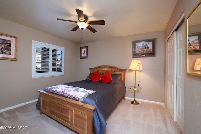 bedroom featuring ceiling fan, light colored carpet, and a closet