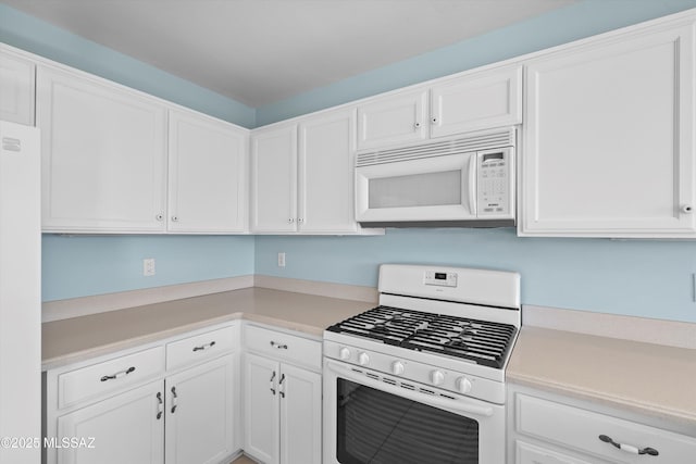 kitchen featuring white cabinets and white appliances