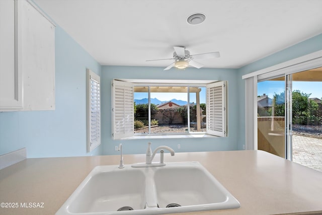 kitchen featuring sink, a healthy amount of sunlight, white cabinets, and ceiling fan