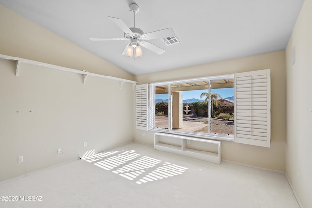 carpeted empty room with ceiling fan and lofted ceiling