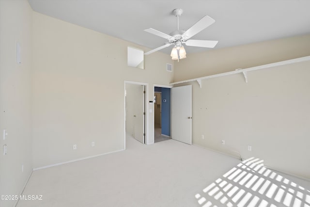 unfurnished bedroom featuring light carpet and ceiling fan