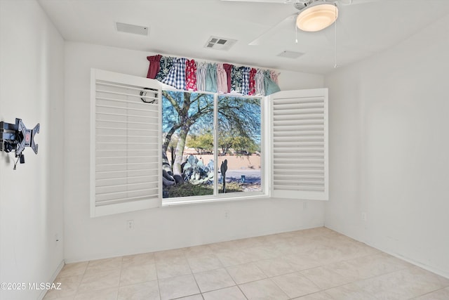 unfurnished room with ceiling fan and light tile patterned floors