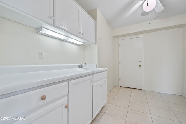 laundry room featuring sink, ceiling fan, and light tile patterned floors