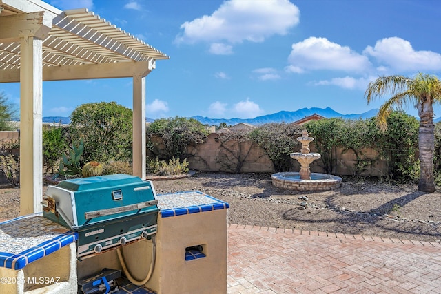 view of patio / terrace featuring a mountain view and a pergola