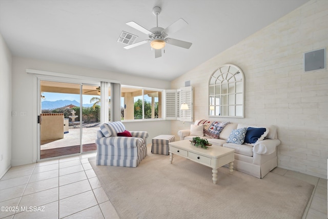 tiled living room with a mountain view, ceiling fan, and vaulted ceiling