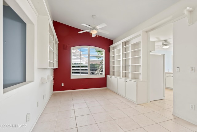 tiled spare room featuring ceiling fan