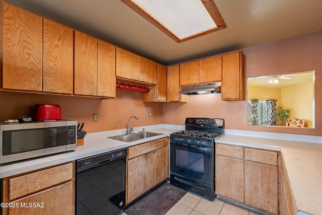 kitchen with black appliances, a sink, light countertops, and under cabinet range hood