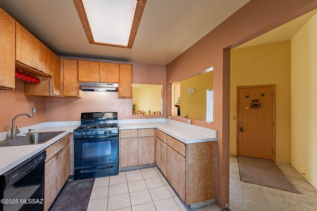 kitchen with sink, light tile patterned floors, and black appliances