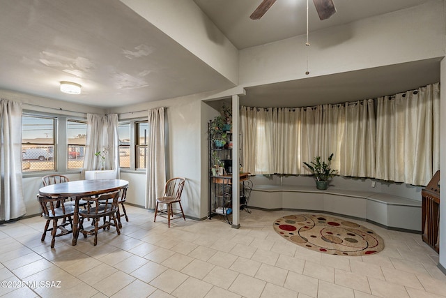 dining area with baseboards and a ceiling fan