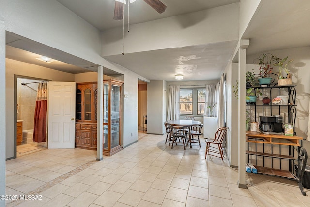 dining space featuring light tile patterned floors and a ceiling fan