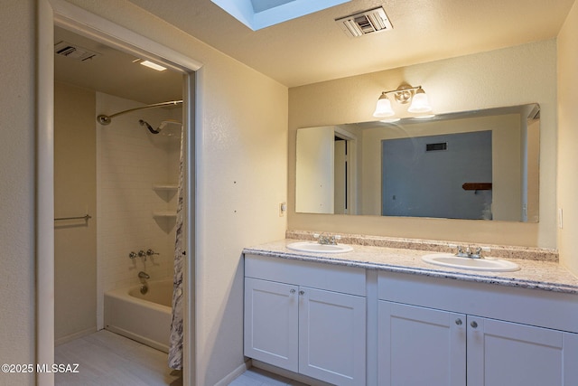 bathroom featuring visible vents, a sink, and double vanity