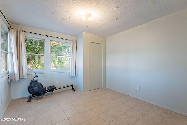 empty room with baseboards and a textured ceiling