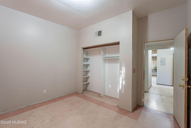 unfurnished bedroom featuring a closet, visible vents, and tile patterned floors