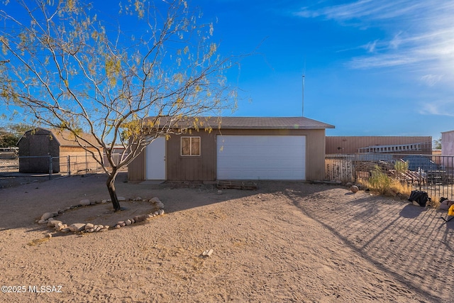 view of front facade with a garage and a shed