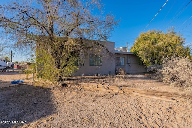 view of front of home featuring fence and stucco siding