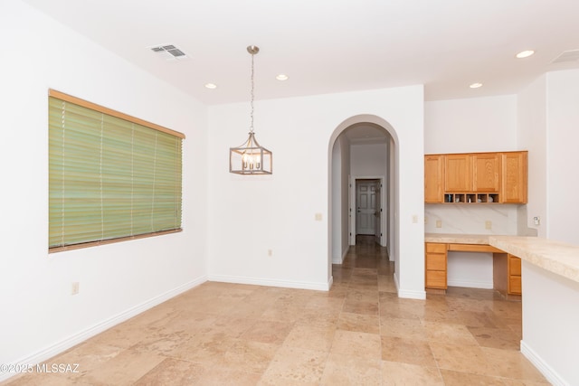 kitchen with a chandelier and hanging light fixtures