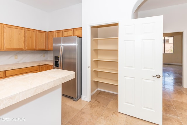 interior space featuring stainless steel fridge with ice dispenser