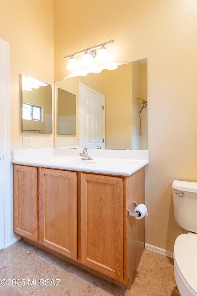 bathroom with toilet and vanity