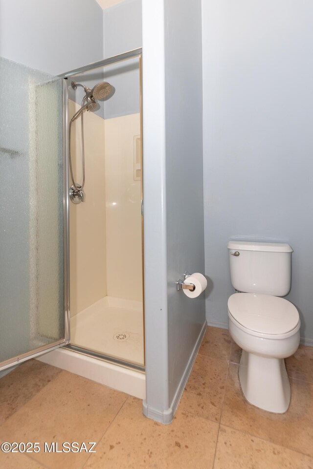 bathroom featuring toilet and an enclosed shower