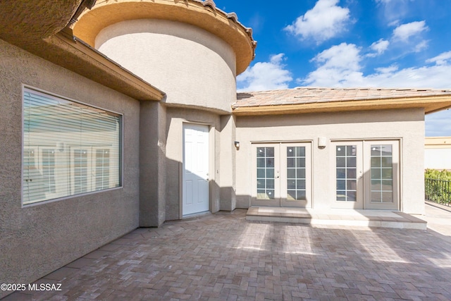 entrance to property with a patio area and french doors