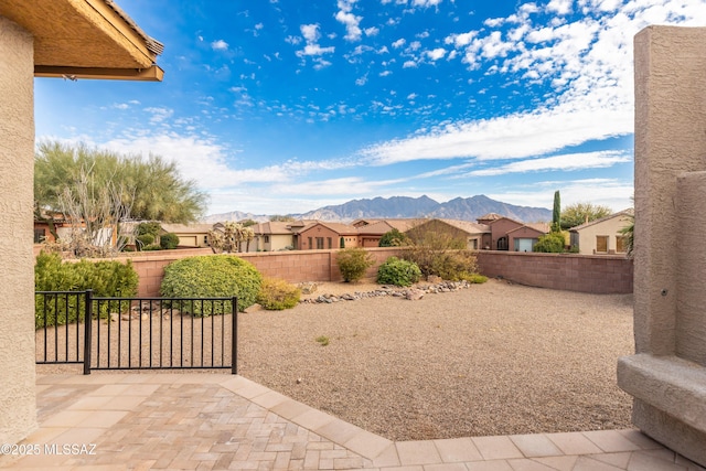 view of yard with a patio and a mountain view