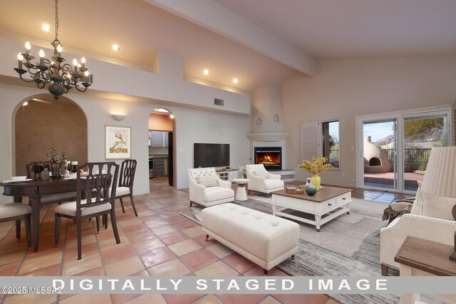 living room with a fireplace, light tile patterned floors, high vaulted ceiling, beamed ceiling, and a chandelier