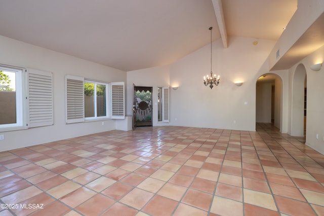 interior space with light tile patterned floors, a chandelier, a healthy amount of sunlight, and beam ceiling