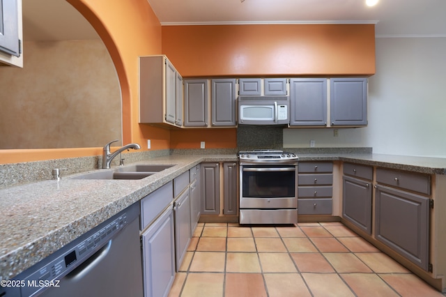 kitchen with gray cabinets, appliances with stainless steel finishes, sink, and light tile patterned flooring