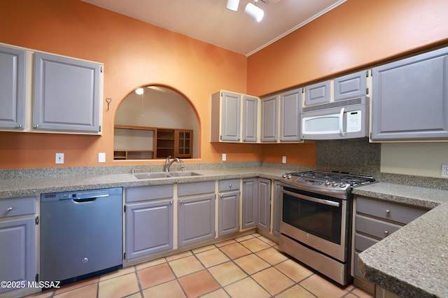 kitchen featuring sink, gray cabinetry, stainless steel appliances, and light tile patterned floors