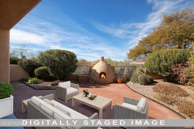 view of patio with an outdoor living space with a fireplace